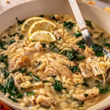 A finished bowl of lemon chicken orzo soup, ready to be served.