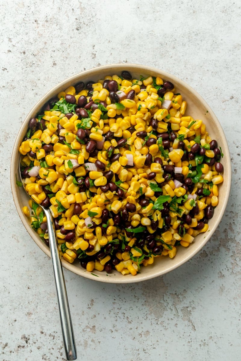 Black bean and corn salsa sits in a light colored bowl.