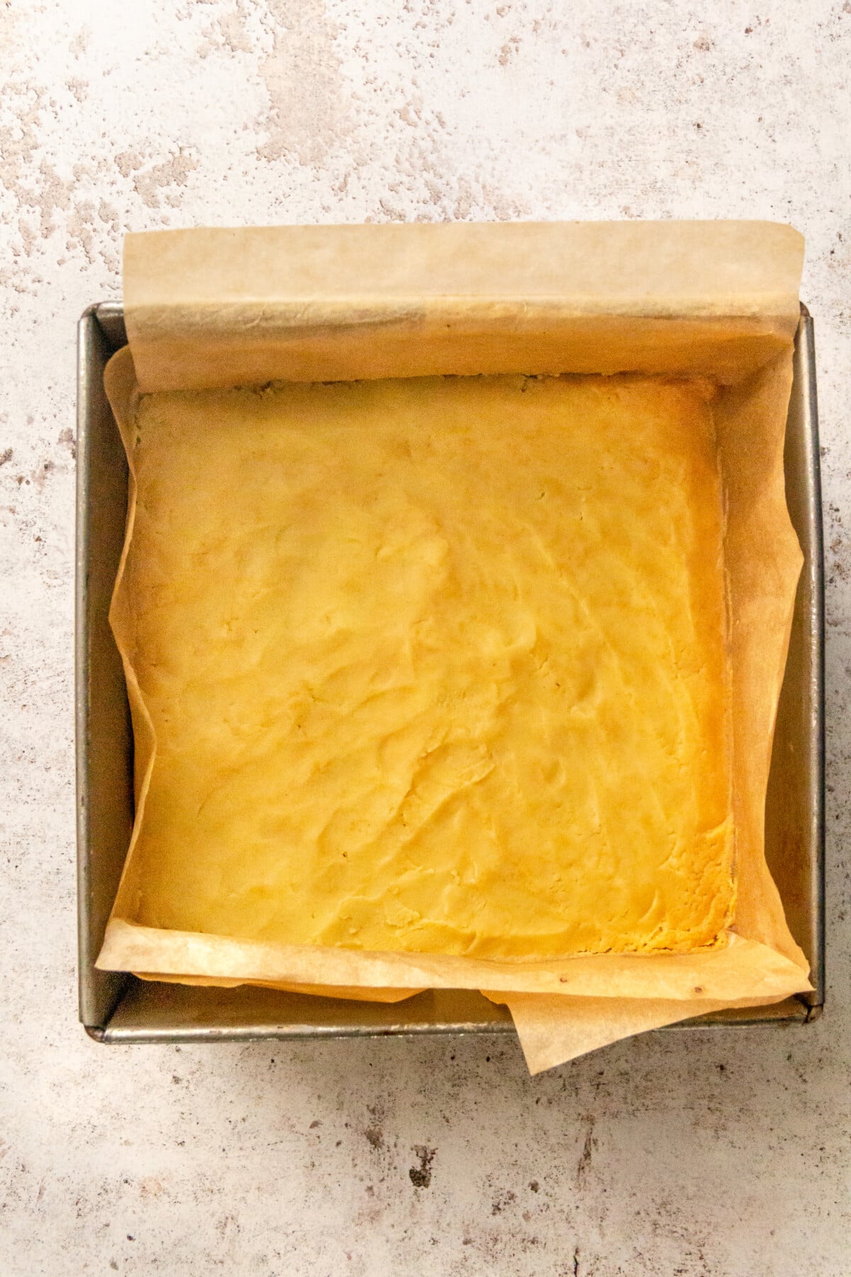 A light yellow colored crust sits in the bottom of the pan.