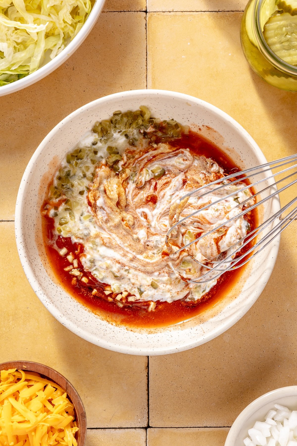 The ingredients for high-protein burger sauce being whisked in a bowl.