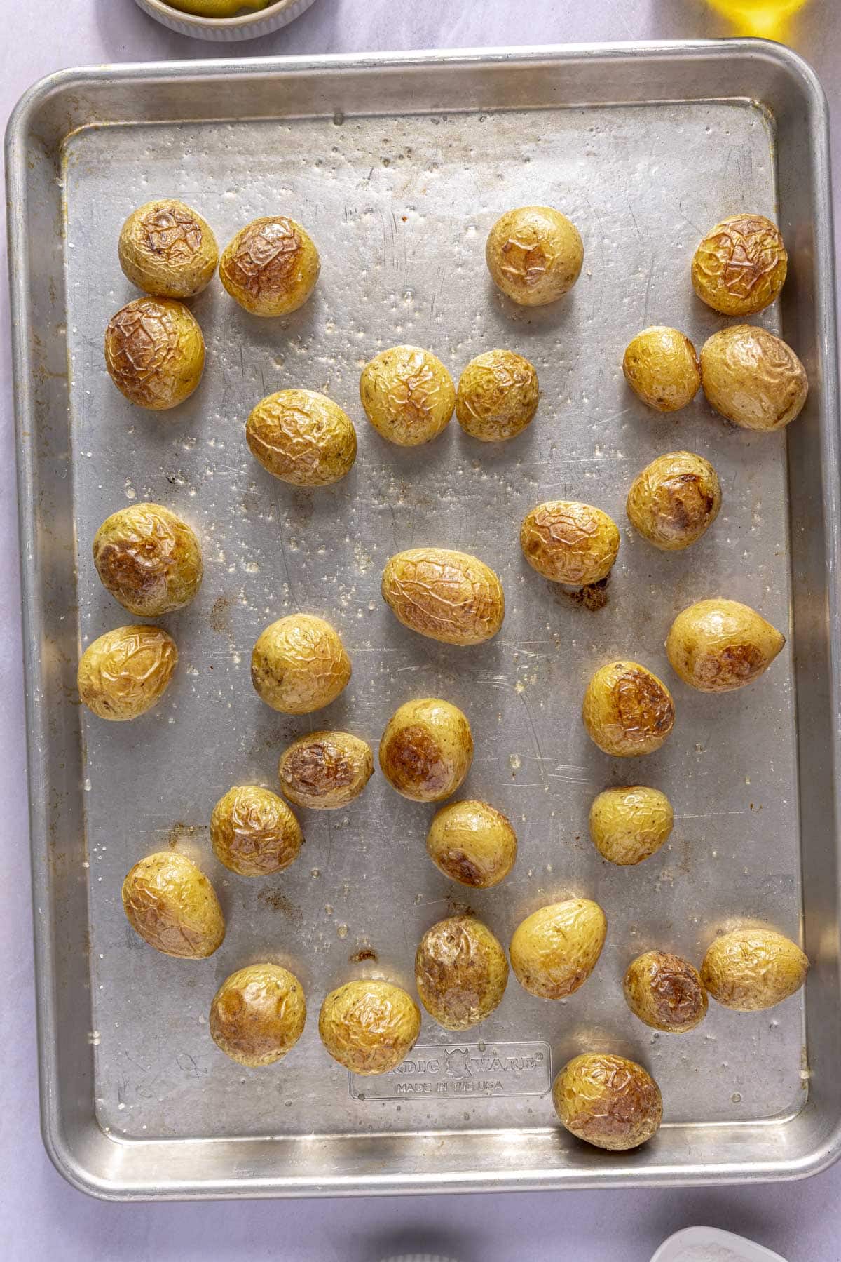 A sheet pan of roasted baby potatoes.