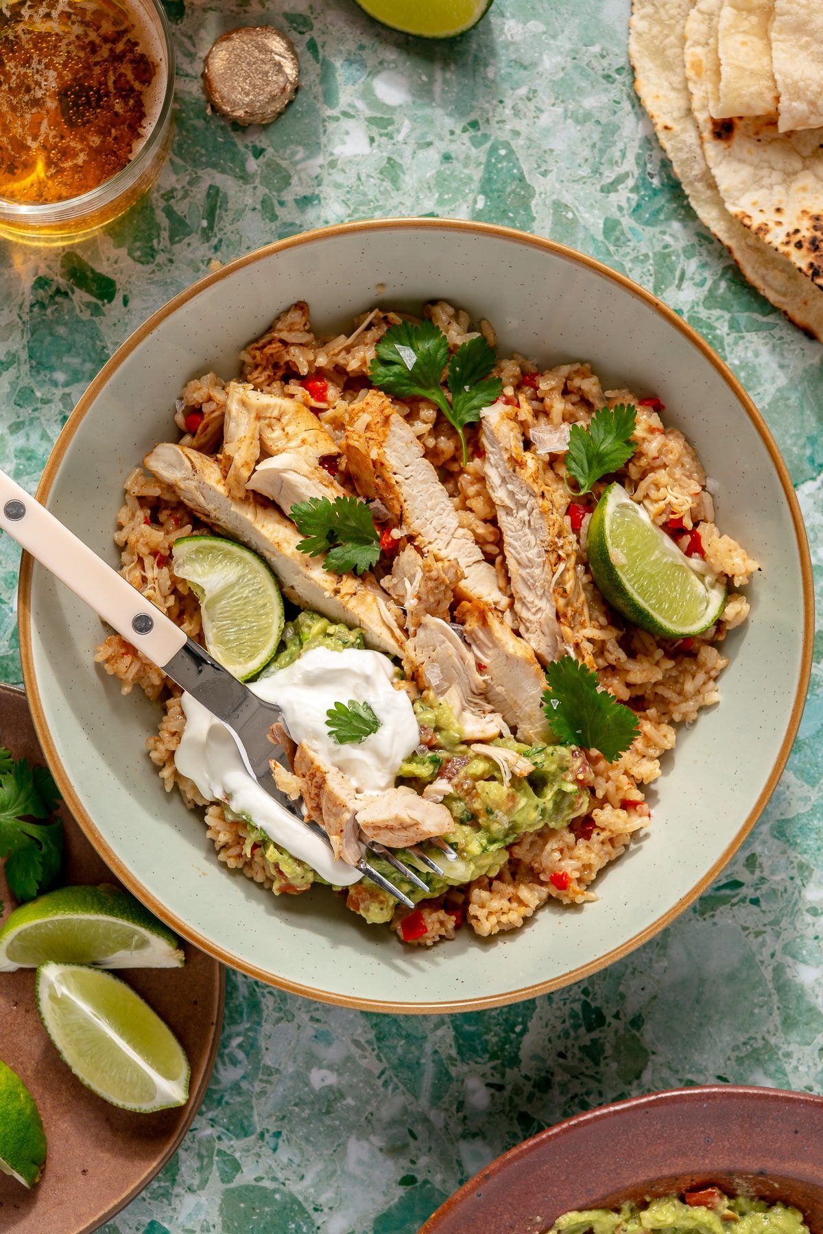 Finished Instant Pot chicken fajitas served with tortilla chips, sour cream, cilantro, and fresh lime.