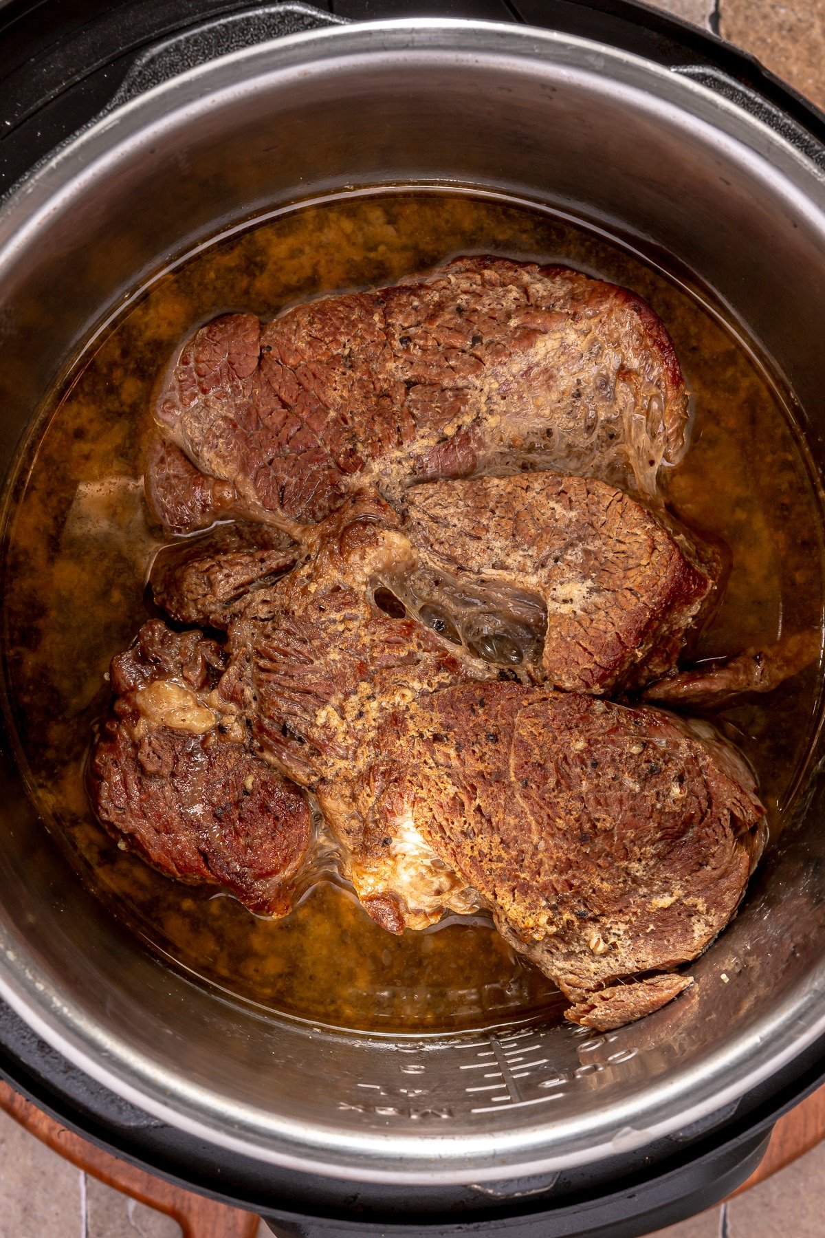 A cooked chuck roast in an Instant Pot.