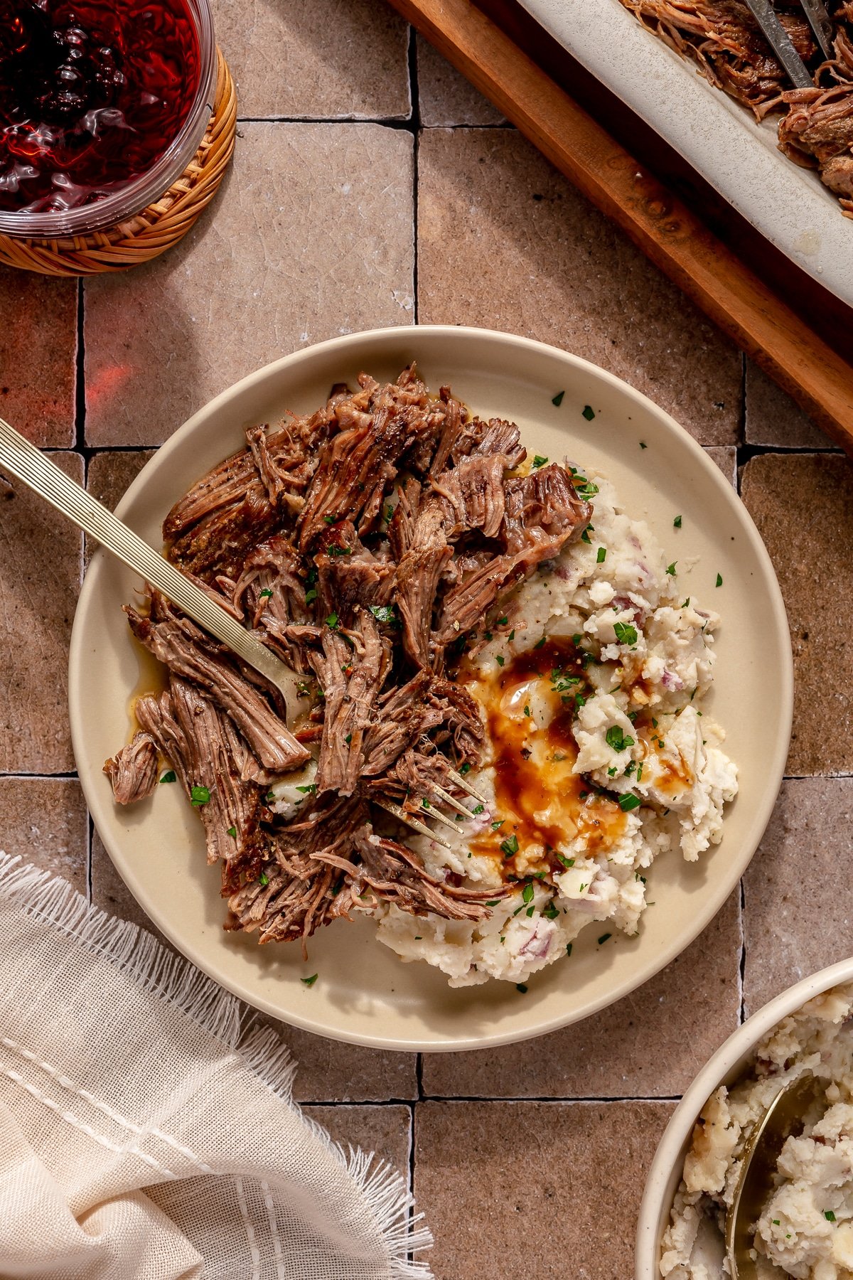 An Instant Pot pot roast served alongside mashed potatoes and gravy.