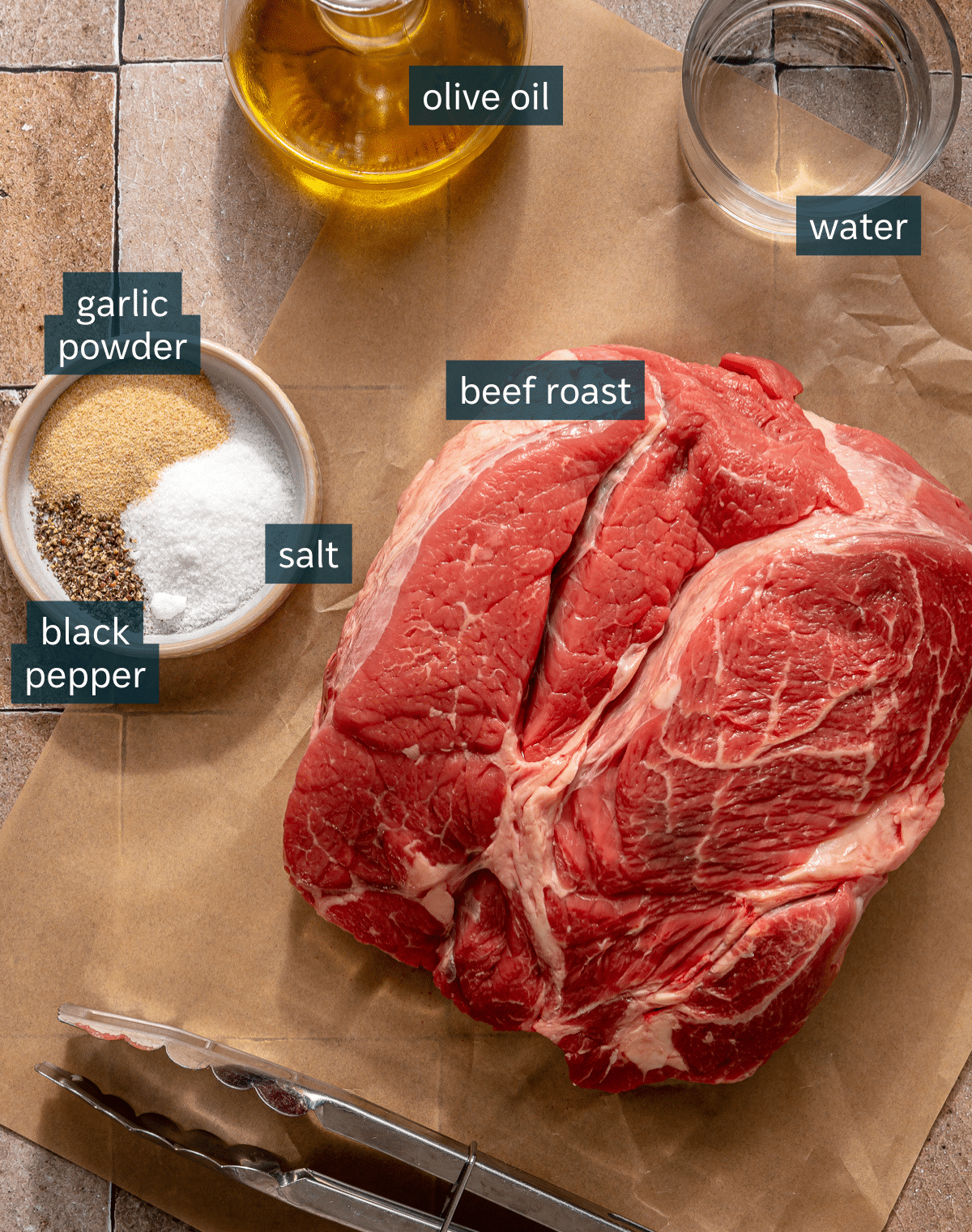 All of the ingredients for Instant Pot pot roast on a brown tile surface.