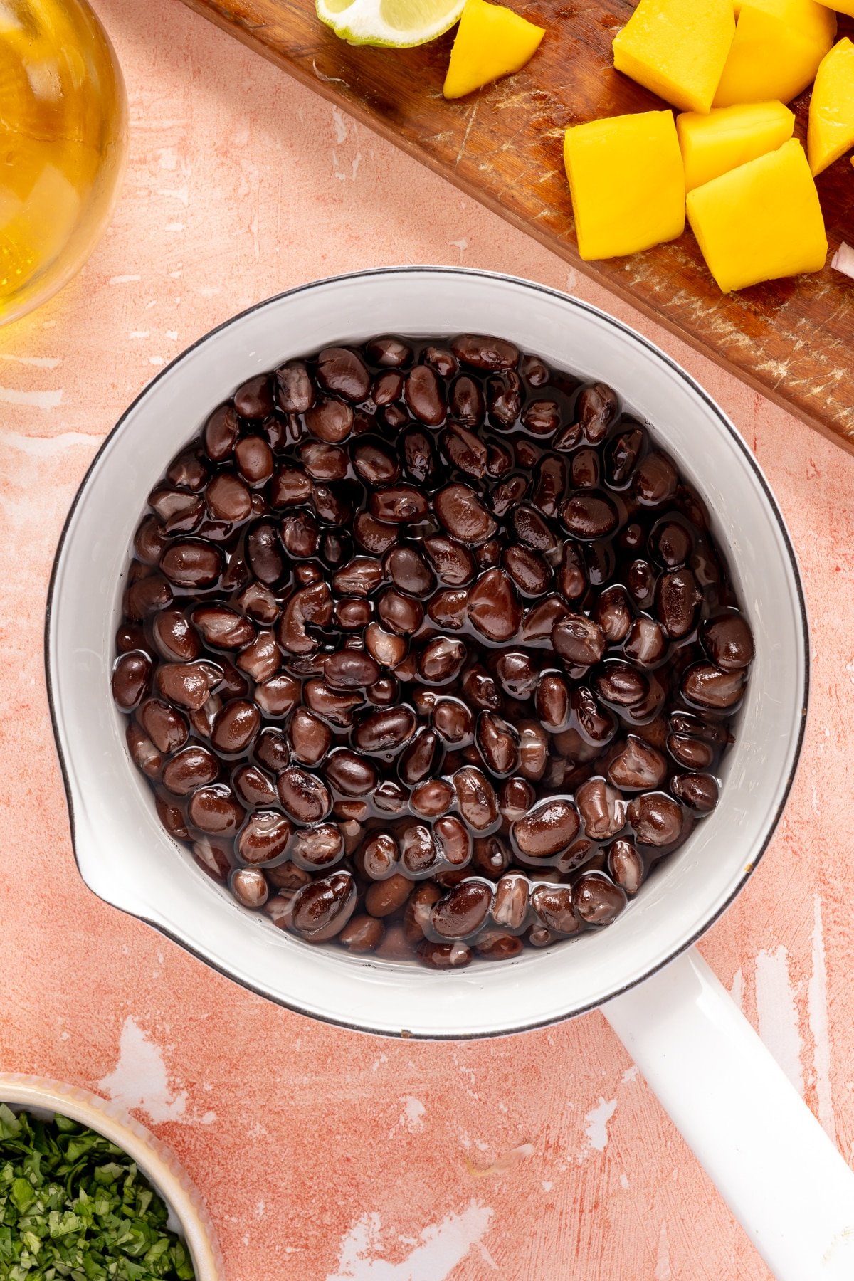 Black beans in a small white pot.