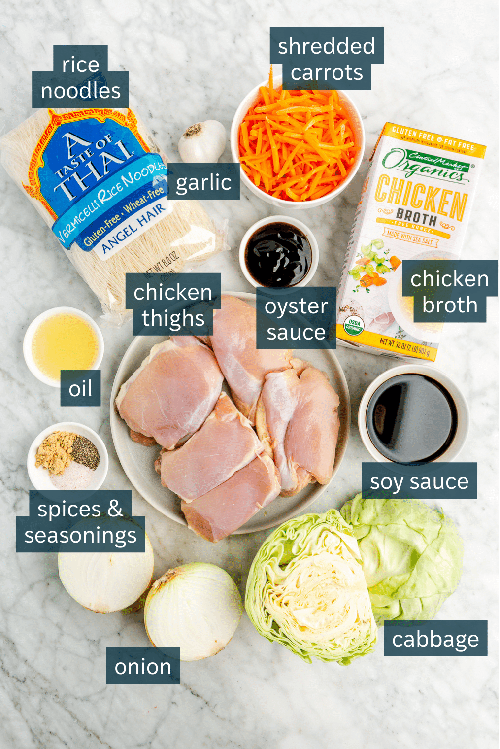 All of the ingredients needed for pancit on a marble surface.