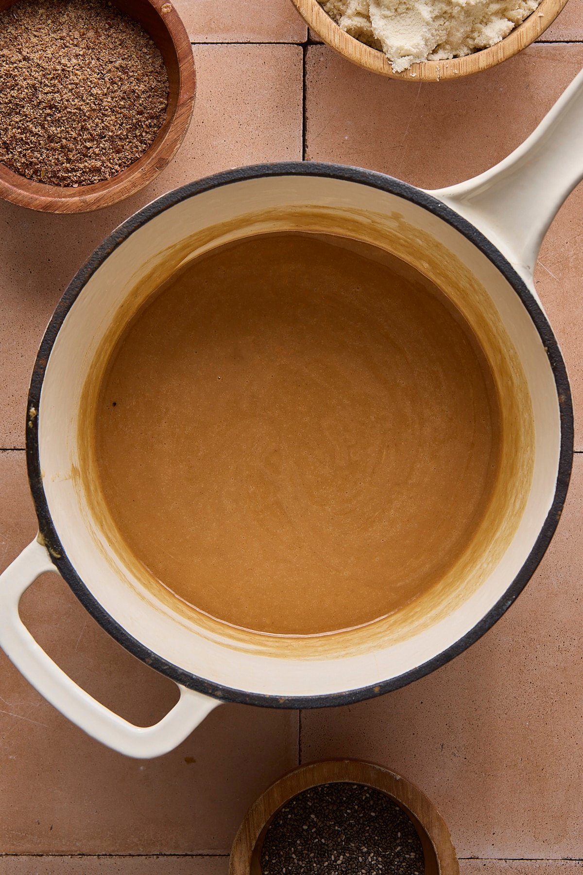 A peanut butter, butter, and honey mixture in a sauce pot.