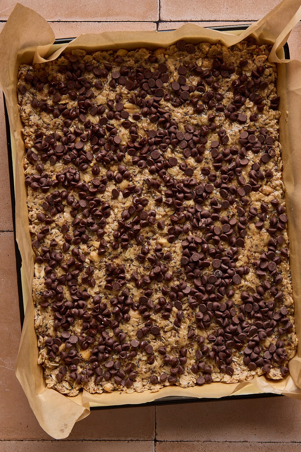 High protein and fiber bars pressed into a baking sheet before being sliced into squares.