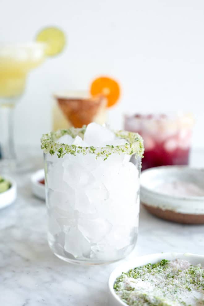 Glass filled with ice and rimmed with salt and lime zest.