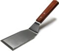 Metal spatula with wooden handle with a white background.