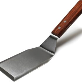 Metal spatula with wooden handle with a white background.