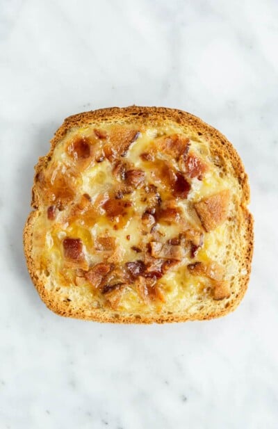 Maple bacon yogurt toast on a grey and white marble surface.