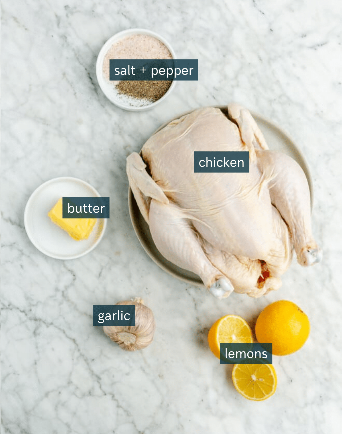 Ingredients, needed to spatchcock a chicken, sit on a marble countertop.