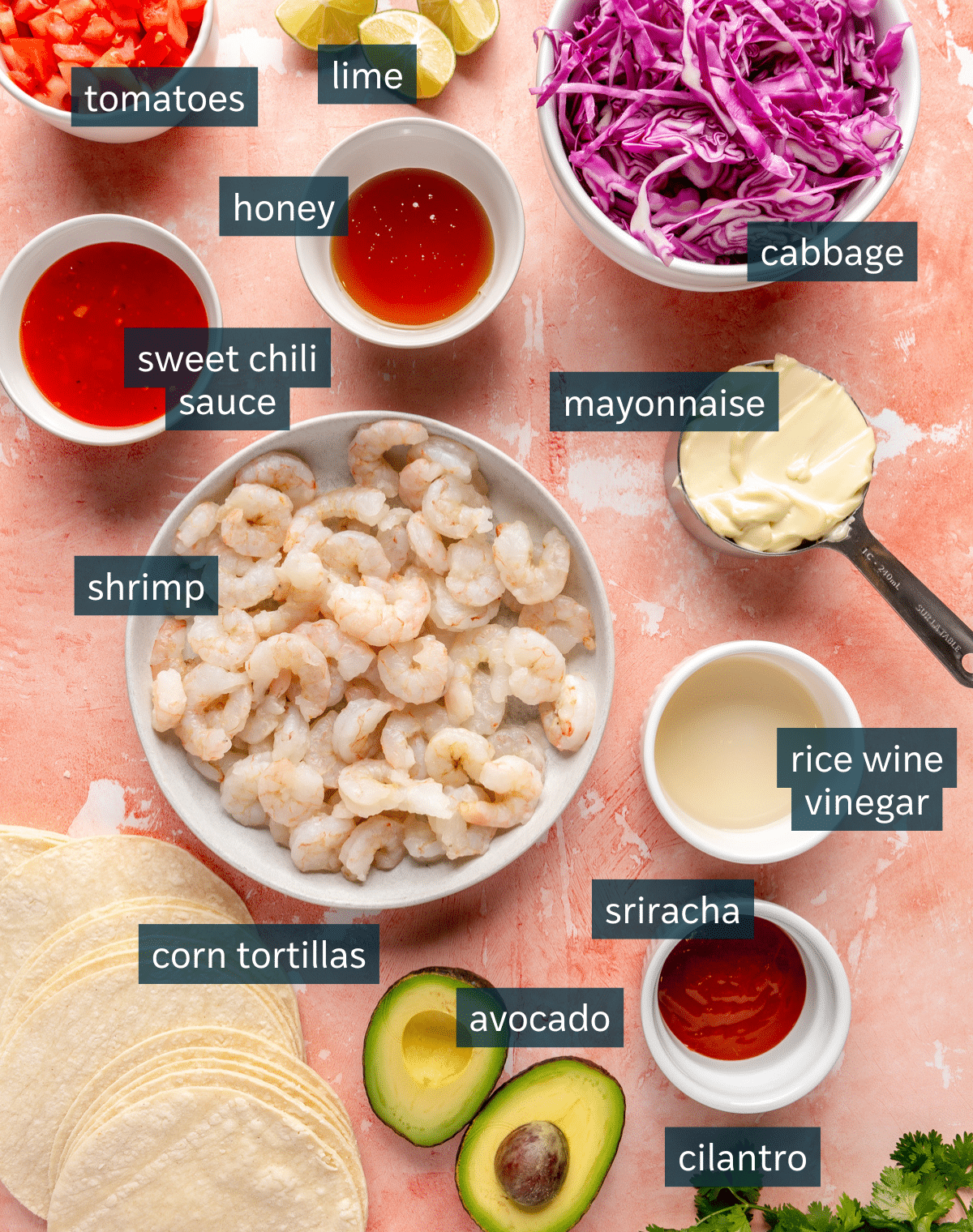 All of the ingredients needed for bang bang shrimp tacos separated into small bowls.